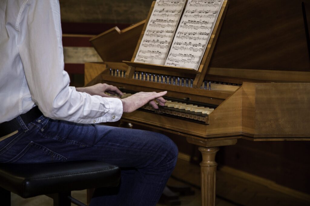 junger Musiker spielt an historischem Klavier